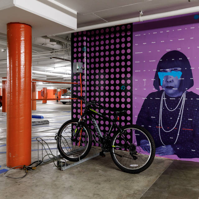 parking garage mural of a woman wearing necklaces