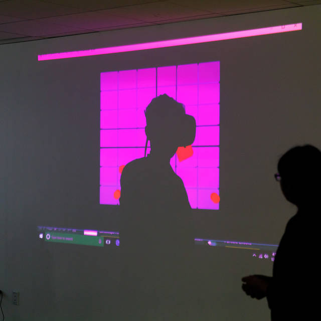 silhouette of person wearing VR goggles
