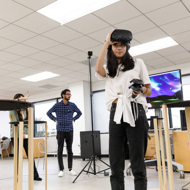 Student raises her VR device