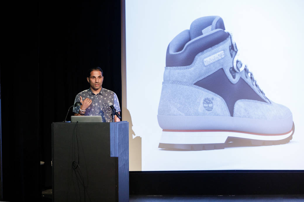 Image of alum Safir Bellali, senior director of advanced digital creation at VF Corporation, presenting during a 2018 Alumni Reunion panel at ArtCenter’s Ahmanson Auditorium