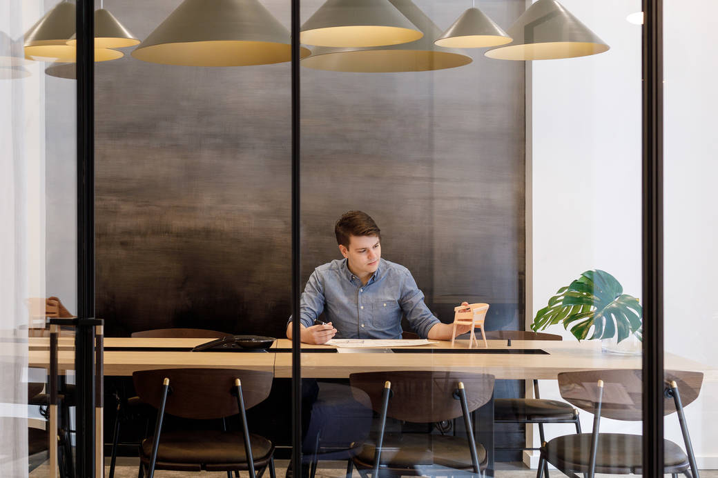 Hines Fischer sitting at a conference table at Workshop/APD in midtown Manhattan