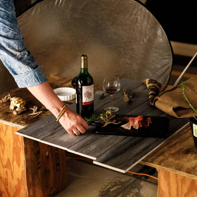 hand adjusting a food set up for a photo shoot