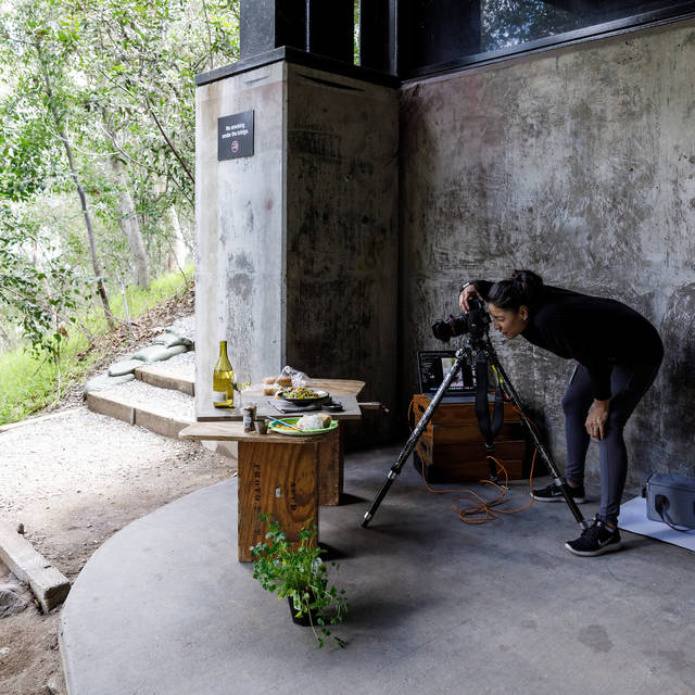 student photographing food set up on a table 