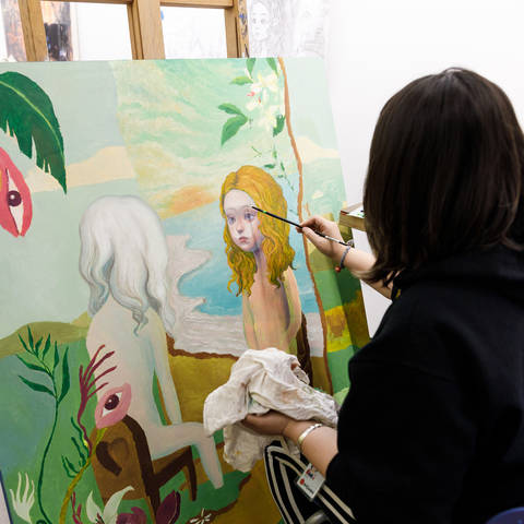 /Student working on a painting