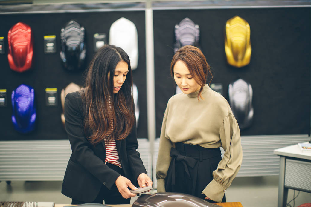 Gypsy Modina, Acura color and materials principal designer, and Acura designer Violet Park showing objects of inspiration for the RDX