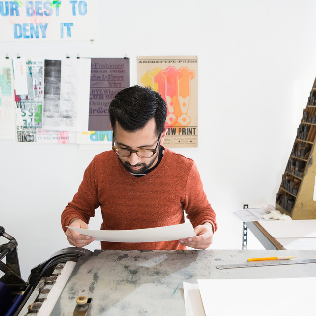 A typography student reviews his letterpress poster