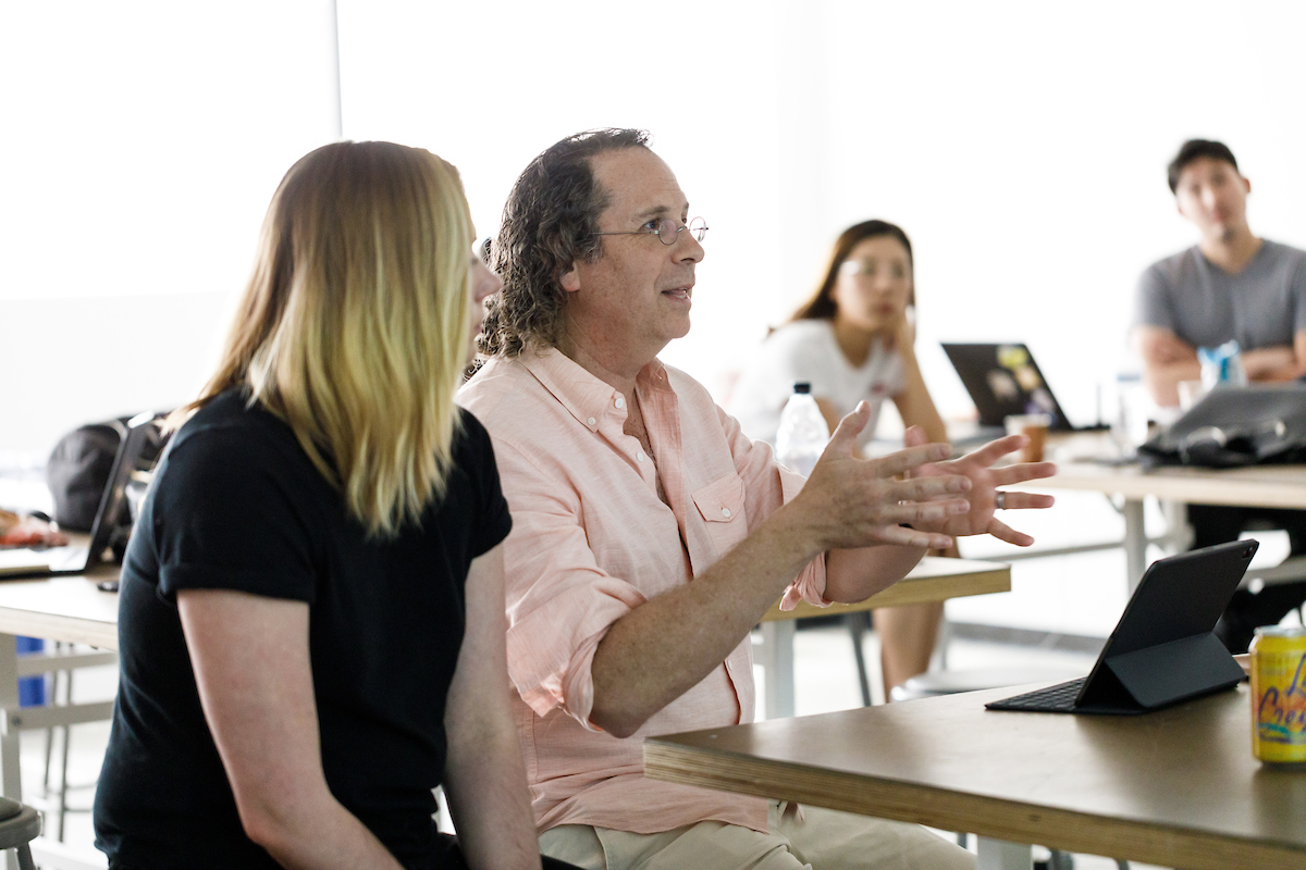 A photo of alum Victor Zaud, IMVU SVP, as he provides feedback to students.