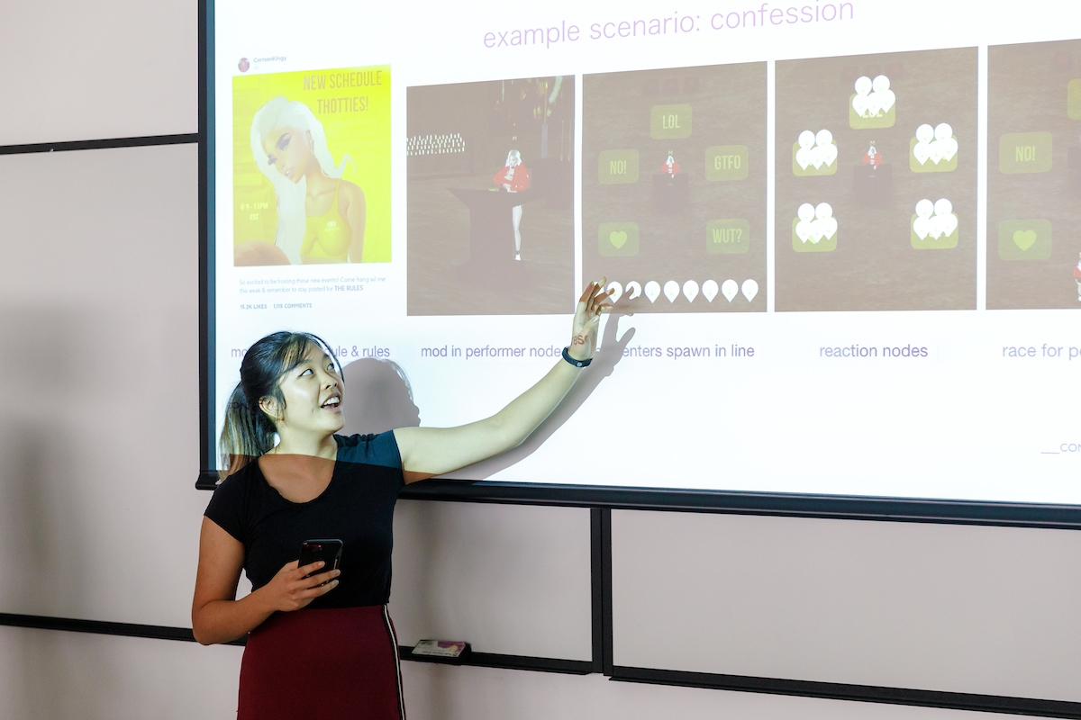 Photo of a student presenting a digital landscape on a board.