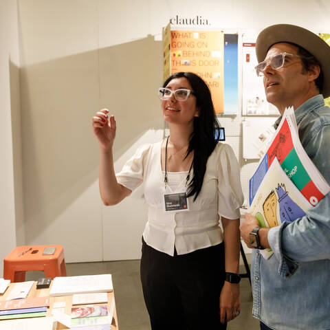 ArtCenter graduate meets with prospective employer at grad show