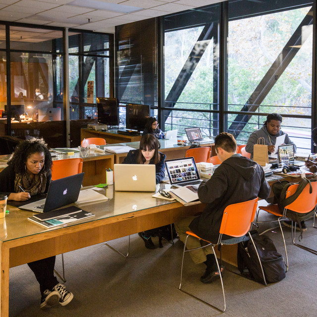 students working on laptops in the library