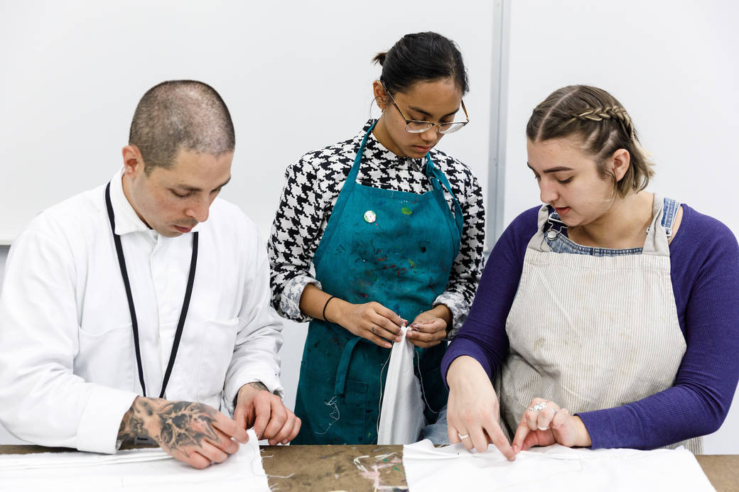 A student dying cloth in vats of indigo in the Spring 2019 TDS Indigo, photo by Juan Posada