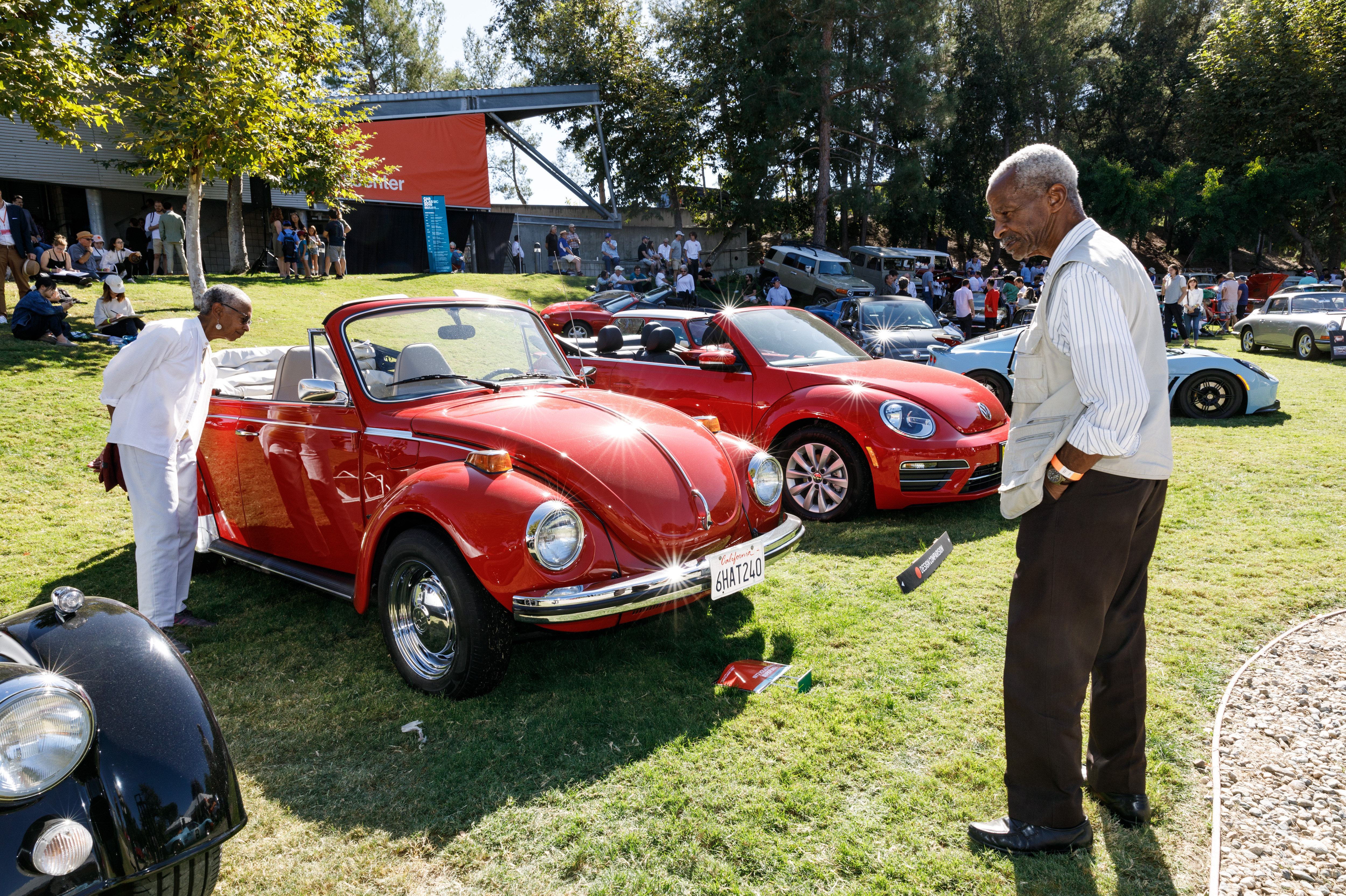 Photo of couple admiring a VW Beetle at Car Classic 2019. 