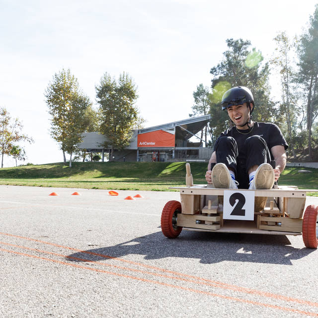 student in a handmade go-cart