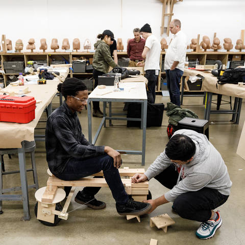 two students working on a go cart