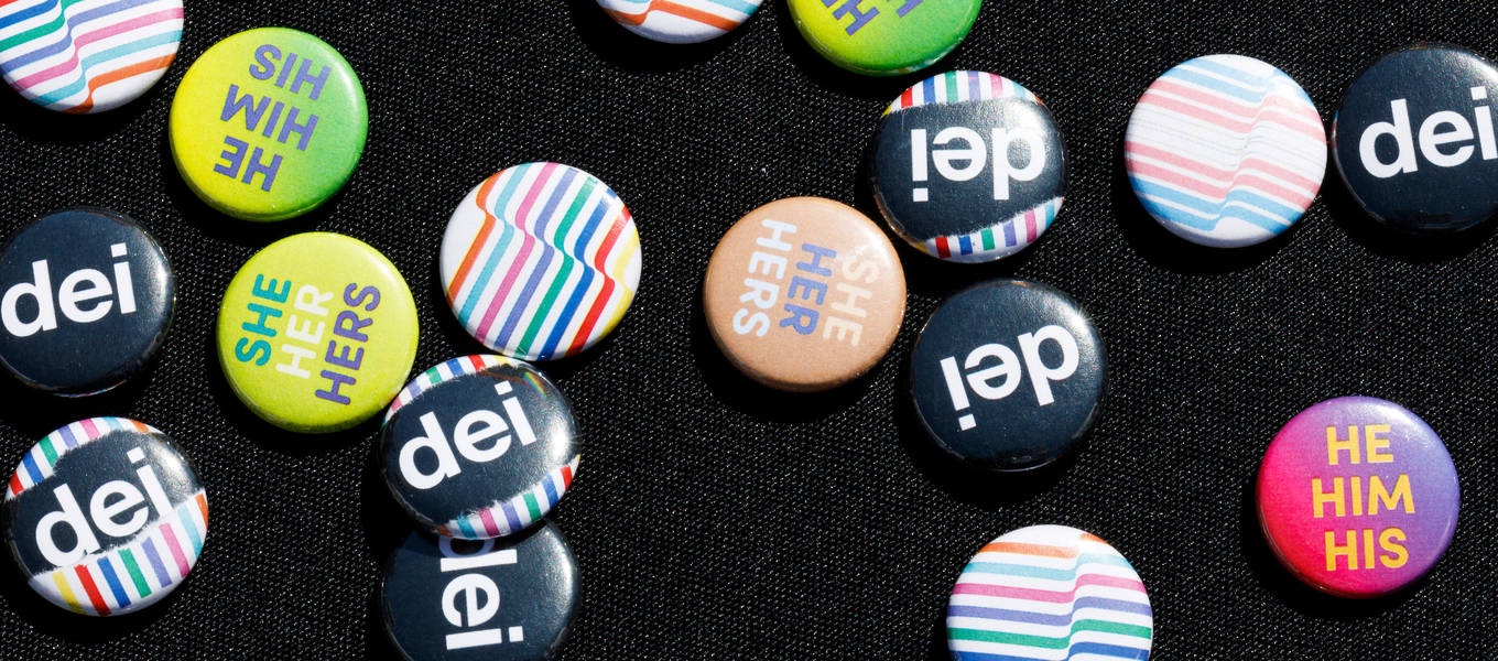 Pins at a Fall 2019 DEI National Coming Out Day flag raising ceremony