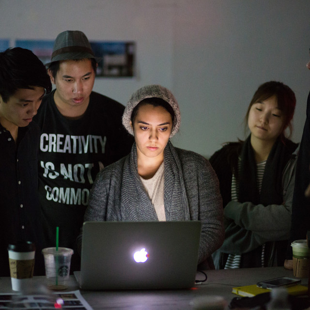 people looking at a laptop screen