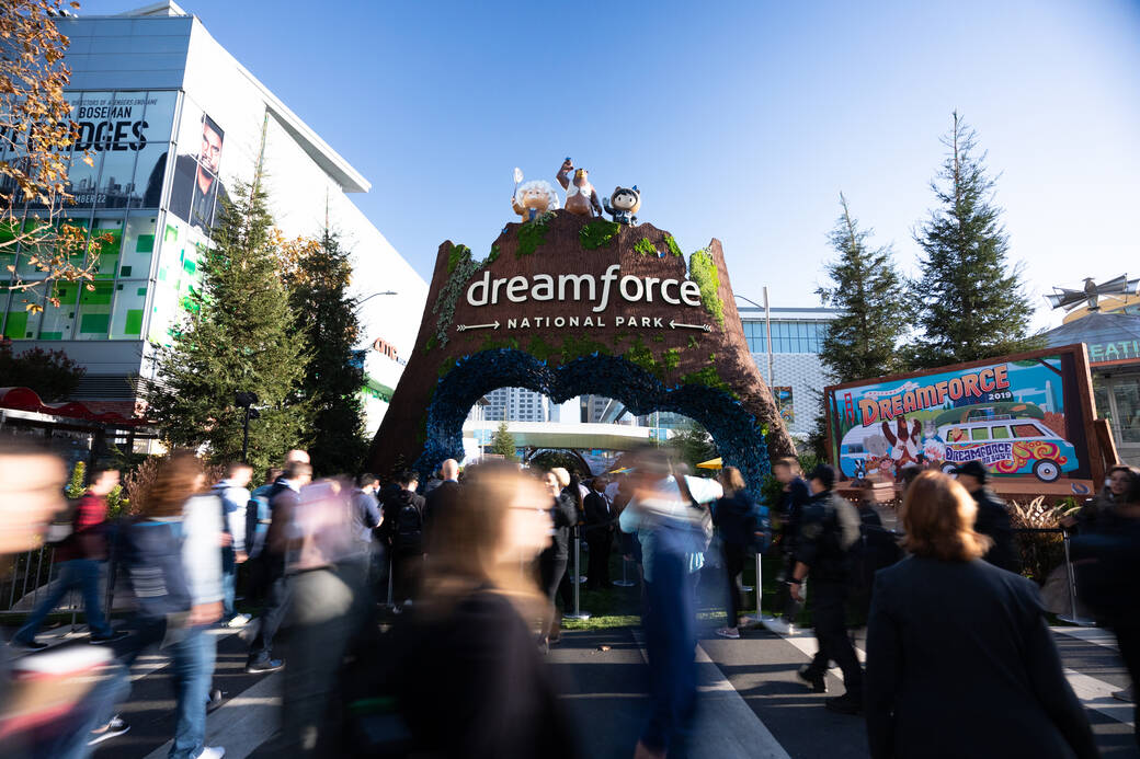 Crowds walk past a National Park-themed gate at Salesforce