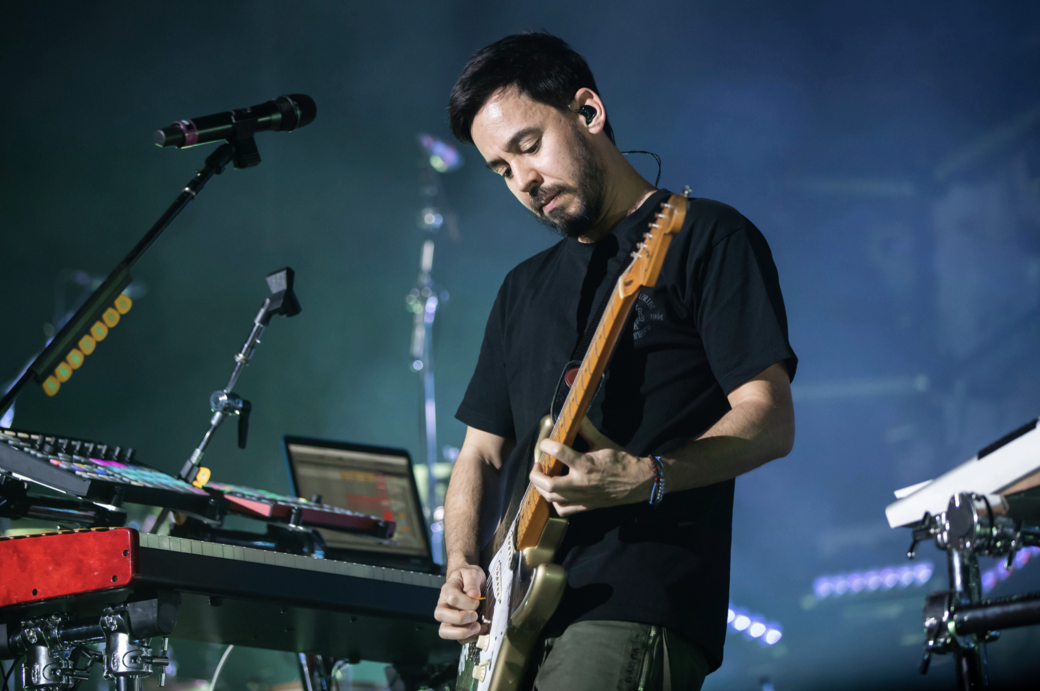Mike Shinoda playing a guitar