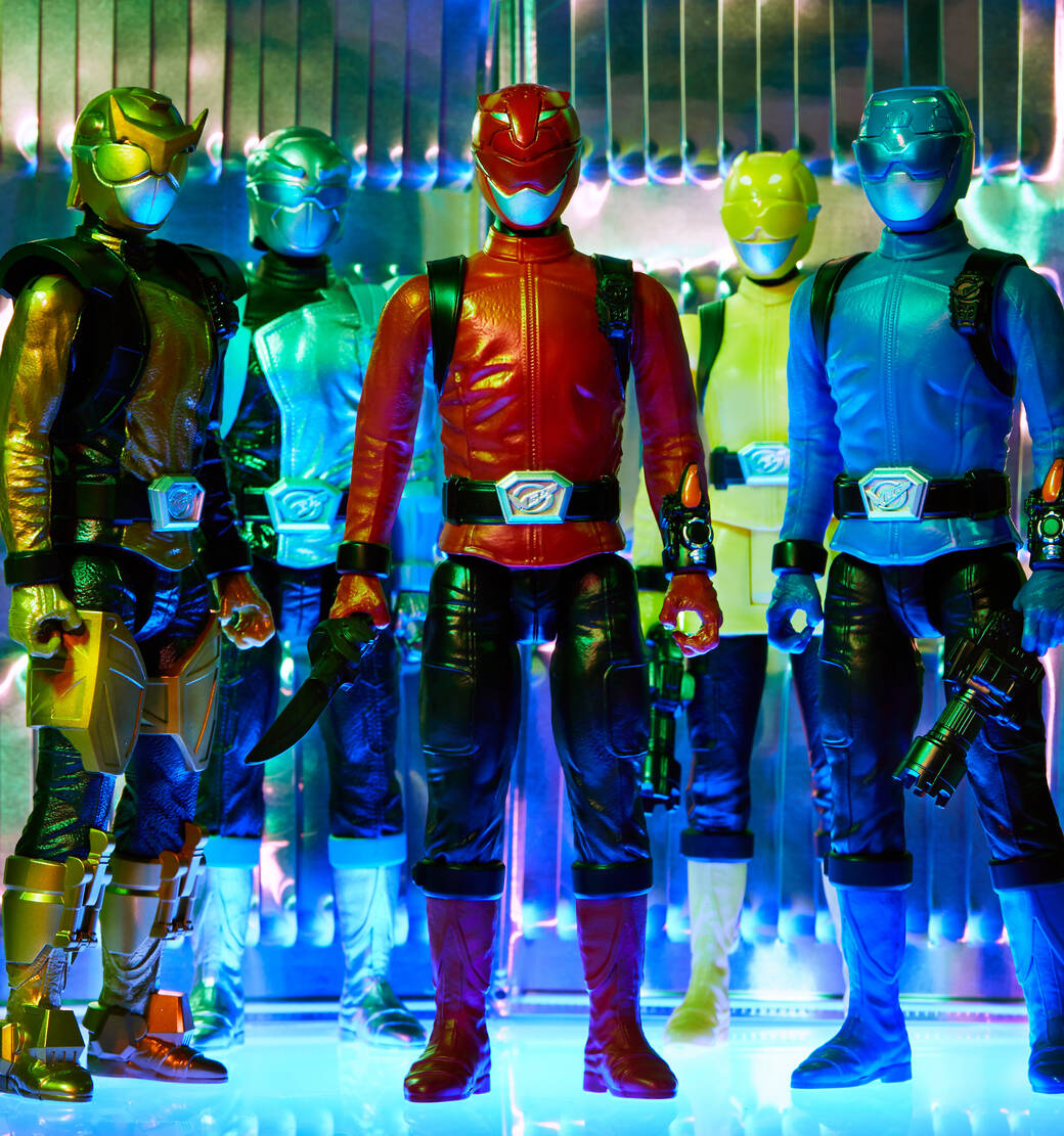 Five dramatically lit Power Rangers Beast Morphers action figures stand in front of a metallic wall and atop a reflective backlit surface.