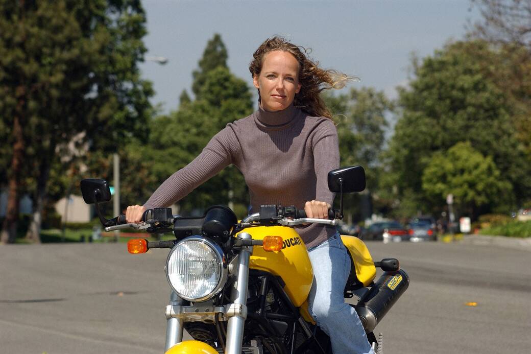 Tisha Johnson on a yellow motorcycle
