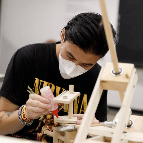 Faculty member and student reviews student car sketches