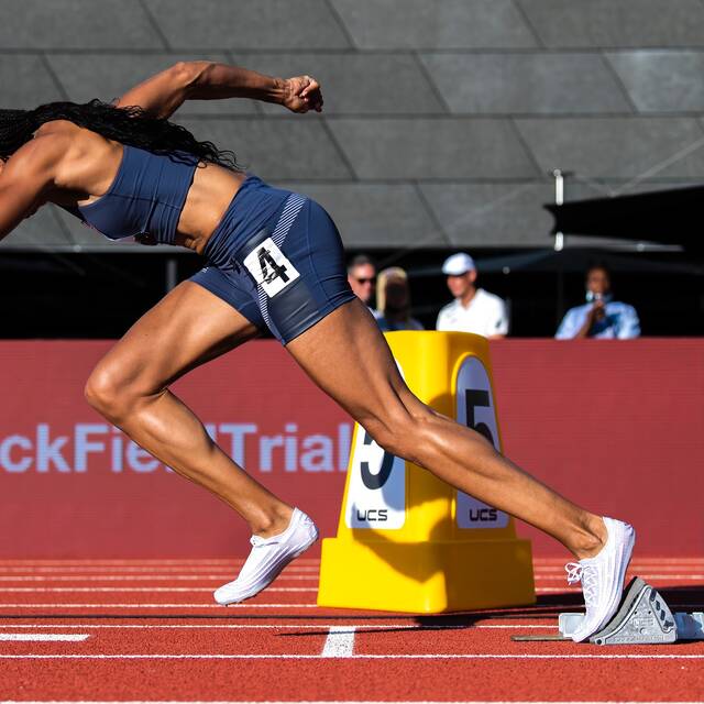 Olympian Allyson Felix takes off from the starting line at the U.S. Track and Field Olympic Trials in 2021, wearing white 0.07 Spike racing shoes from Saysh