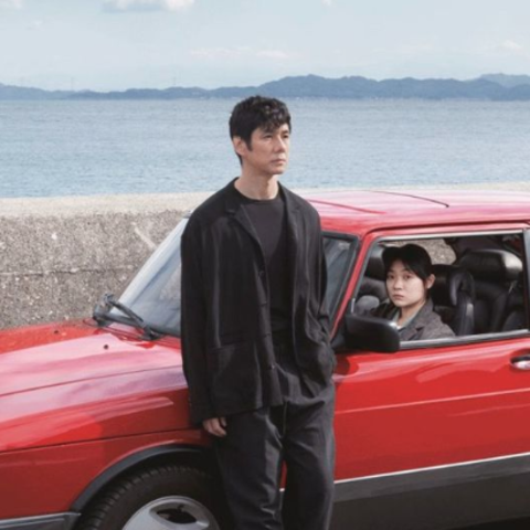 /man standing outside red car, woman sitting in car