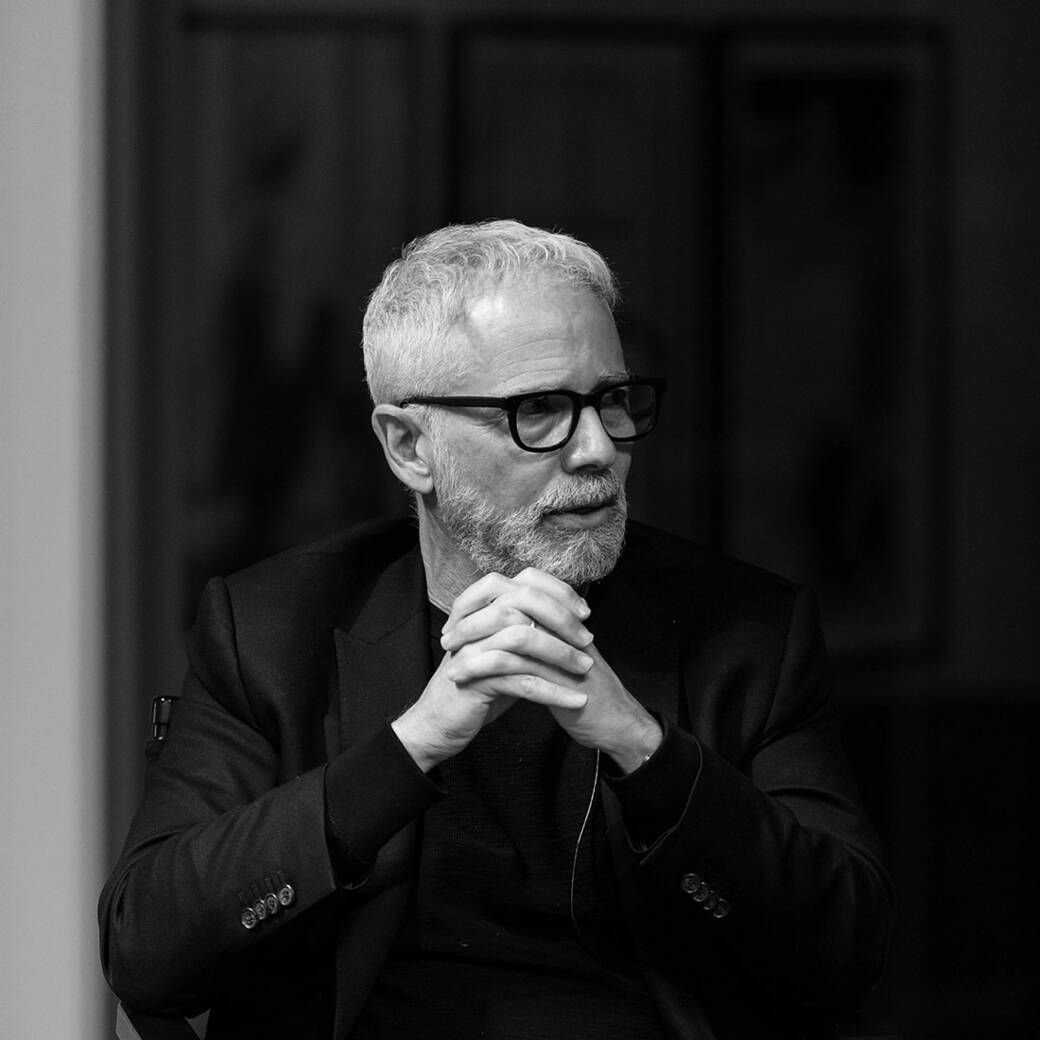 Black-and-white photograph of ArtCenter President Lorne M. Buchman, bearded and wearing glasses, speaking at an event for the release of his book Make to Know.