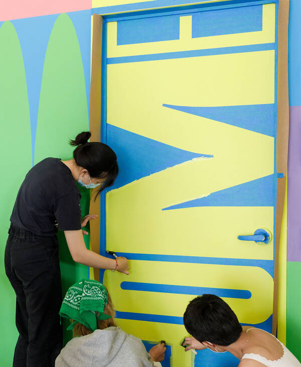 Students installing a new mural at ArtCenter