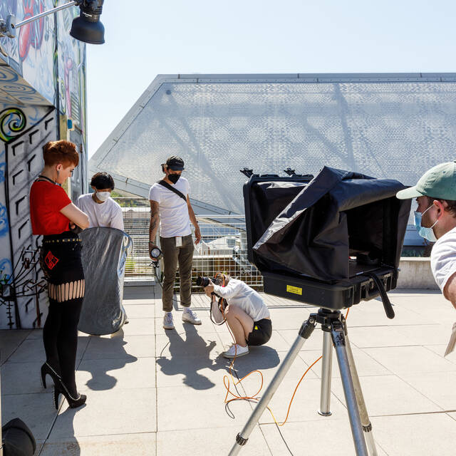 student photographer taking a portrait of a woman