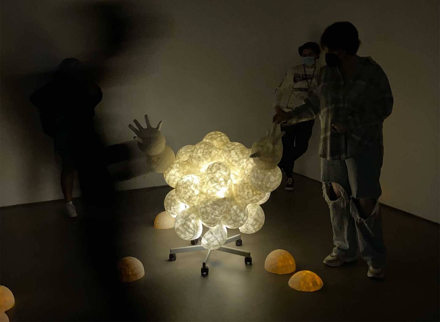 interactive+performative+installation+with+molded+paper+sculpture%2C+lights%2C+gloves%2C+chair+with+wheels.