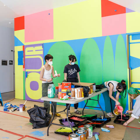 ArtCenter students paint a mural in the 1111 building.