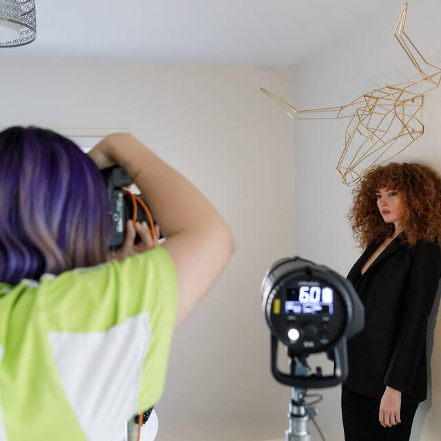 Photography student photographs a model on location