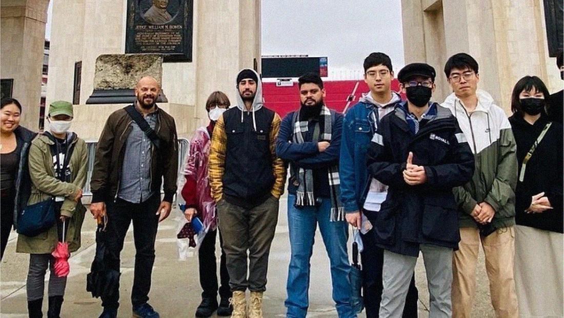 Cedric Johnson and students stand infront of the LA colleseum