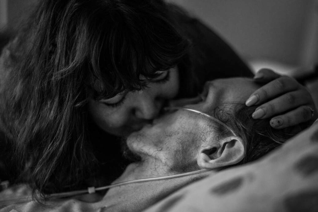 Self portrait Is This the Last Kiss? by alum Amanda Villegas of her with her late husband Chris, 2019, at their apartment in Upland, Calif., where he died of aggressive bladder cancer. 