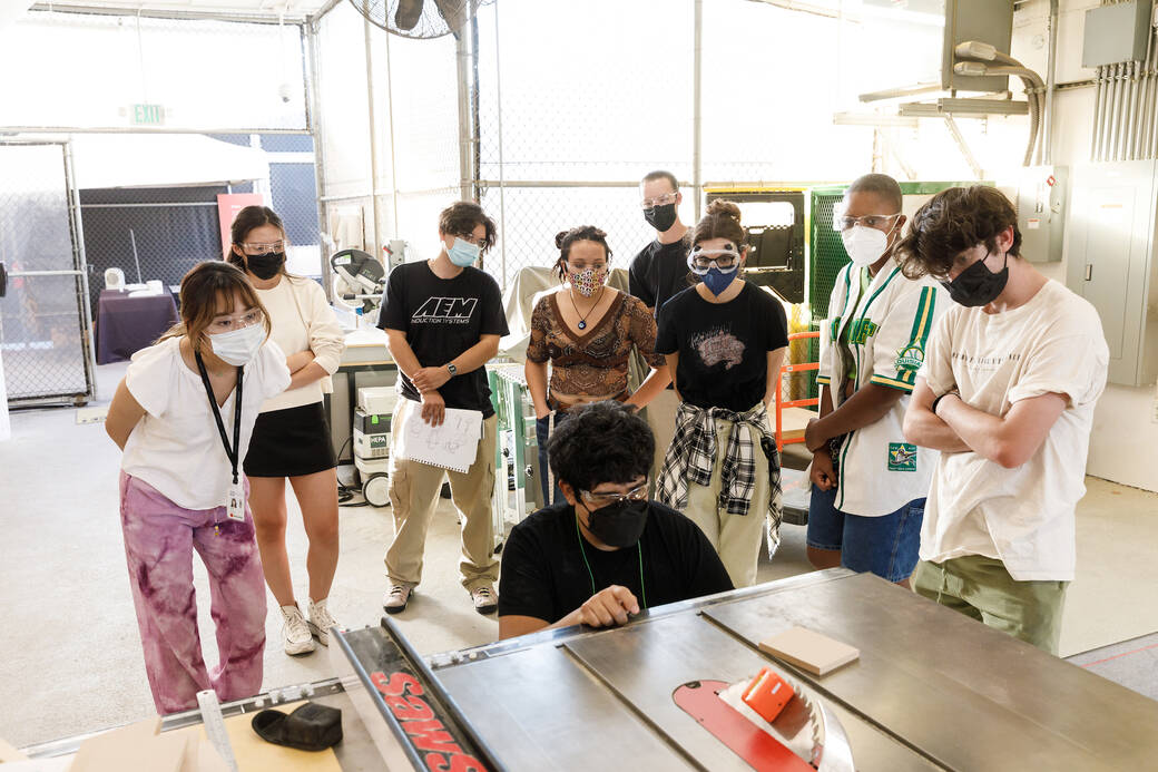 First Year Immersion student Ryan Miller (right) with Integrated Studies Assistant Professor Robert Lepiz (bottom, middle) and other students at the Shop at South Campus, for the course Shop Skills Materials Lab, taught by Lepiz, Fall 2022. Photo by Juan Posada.