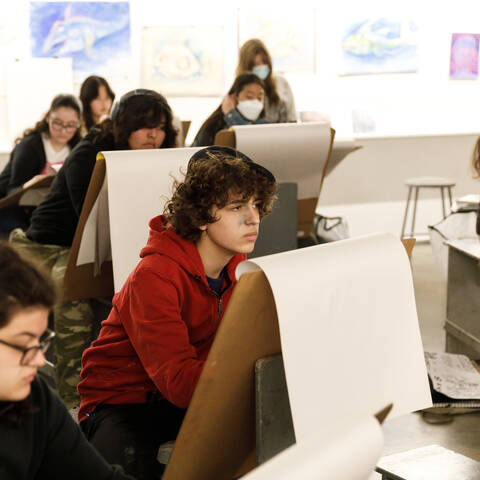  High school students collaborating on art and design projects in a bright, hands-on classroom at ArtCenter.