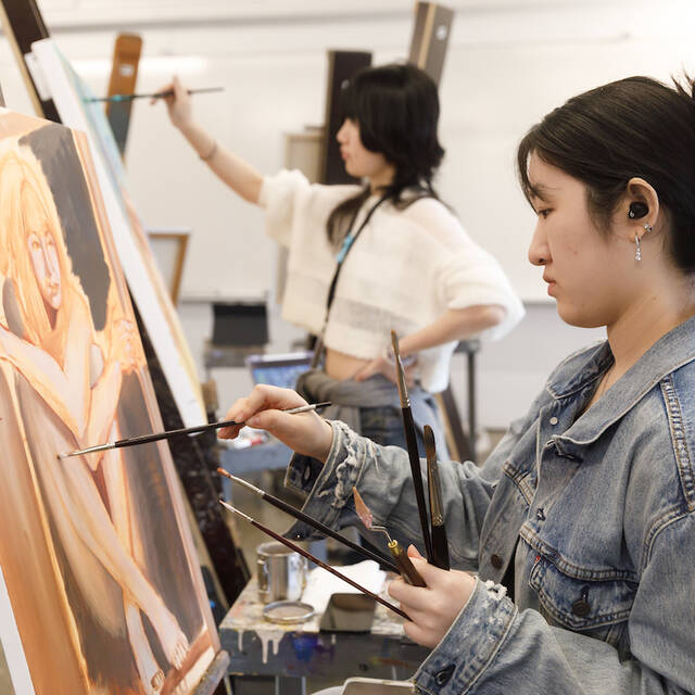 An ArtCenter student paint on canvas in a studio painting class