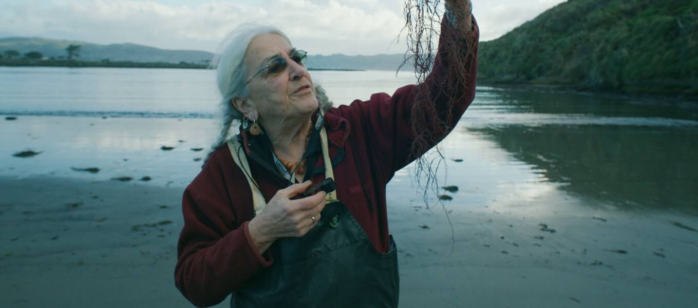 Dr. Kathy Ann Miller stands on a beach in California