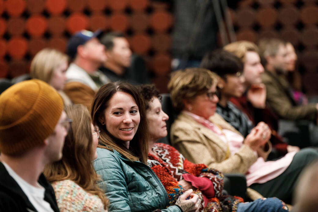 Julia Marsh speaks, surrounded by four other panelists in the Ahmanson Auditorium during the 