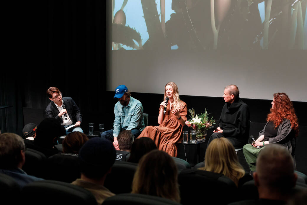 Julia Marsh speaks, surrounded by four other panelists in the Ahmanson Auditorium during the 