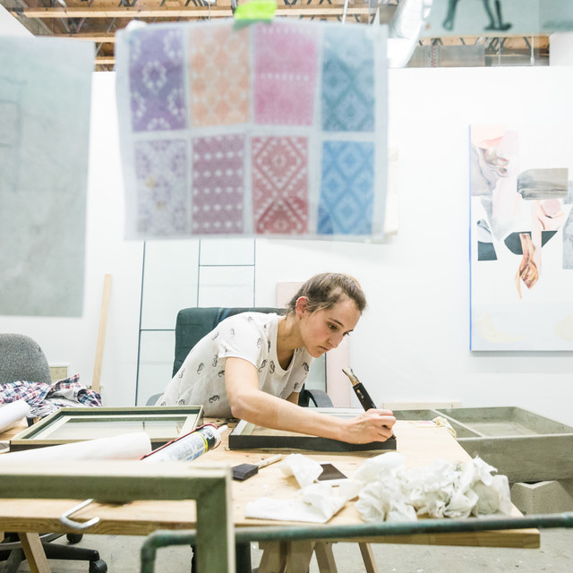 An ArtCenter Fine Art Student works on her art piece in her studio at South Campus