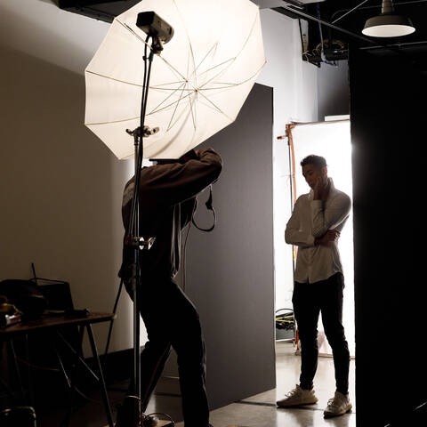 A student taking a portrait shot of another studetn the in the Sound Stage at ArtCenter