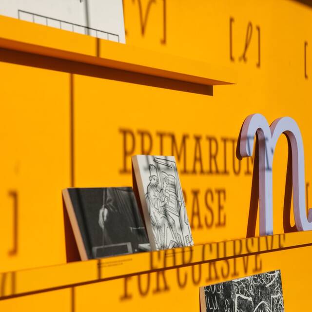 Gallery view of Primarium: A Case for Cursive exhibition featuring historical manuscripts, interactive displays, and global scripts highlighting the evolution of cursive writing.