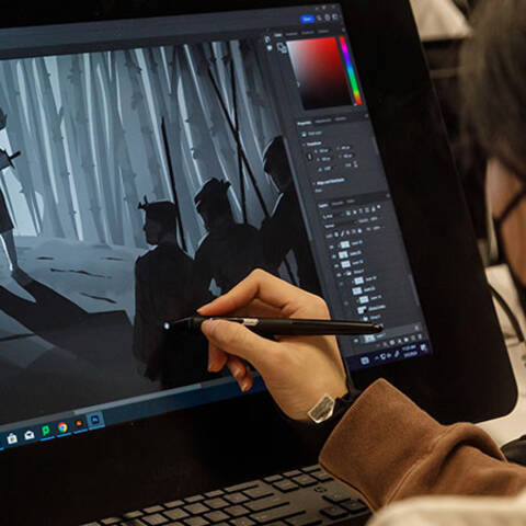 /High school student designing characters and environments in Character and Worlds class at ArtCenter Summer Extension, sketching scenes and figures.