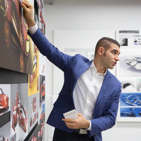 /Student presents his car design during critique