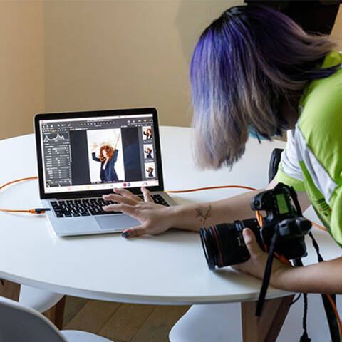 /High school student taking photos in Digital Photography class at ArtCenter Summer Extension, learning composition and lighting techniques.