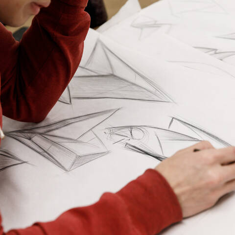 /High school students sketching in Car Design class at ArtCenter Summer Extension, working on vehicle sketch.