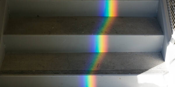 a rainbow reflected onto a staircase