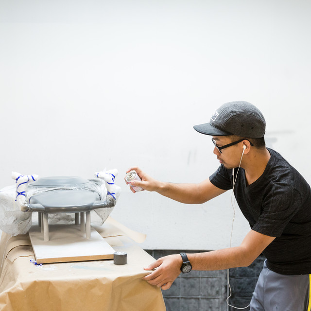 ArtCenter student spray paints his product design model